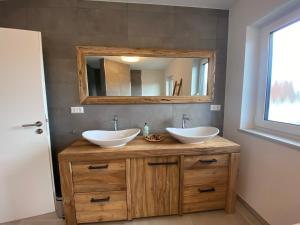 a bathroom with two sinks and a mirror at TLA-A-K83a in Bruchmühlbach-Miesau