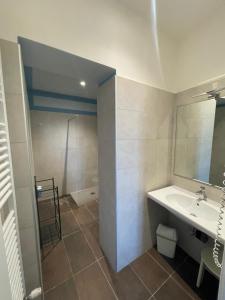 a bathroom with a sink and a mirror and a shower at Riolo Terme Camere in Riolo Terme +8 photos