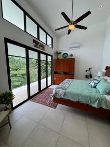a bedroom with a bed and a ceiling fan at Villa Montemar Ocean and Mountain Views in Platanillo +90 photos