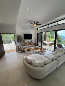 a large living room with a large couch and tables at Villa Montemar Ocean and Mountain Views in Platanillo
