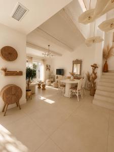a large living room with a table and chairs at Villa Boho Cassis in Cassis