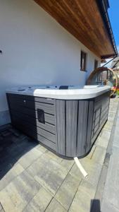 a hot tub sitting outside of a building at Apartamenty Oliwia Jacuzzi & Sauna in Małe Ciche