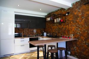 a kitchen with white cabinets and a wooden counter top at Pod Lwią Górą in Strużnica
