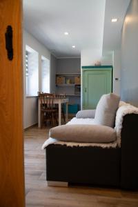a room with a bed and a dining room with a table at Pod Lwią Górą in Strużnica