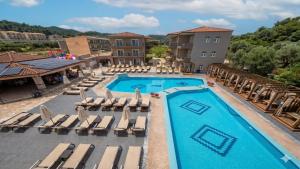 an image of a pool at a resort at Royal Hotel and Suites in Polychrono