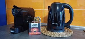 a tea kettle on a counter next to a coffee maker at Il Falcineto in Pesaro