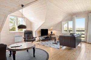 a living room with a couch and a table at LF15156-Hojslev-Mosevej-156 in Højslev