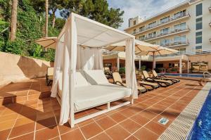 a soak up the sun in a gazebo next to a pool at Hotel ROC Oberoy - Adults Only in Paguera
