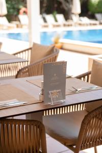 a book sitting on top of a wooden table at Hotel ROC Oberoy - Adults Only in Paguera