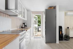 a kitchen with white cabinets and a refrigerator at LF16310-Nibe-Alerusen-97 in Nibe +18 photos