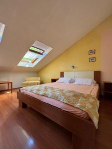 a bedroom with a large bed with a skylight at Apartment Kordić in Sveta Nedelja