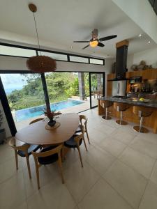 a kitchen and dining room with a table and chairs at Villa Montemar Ocean and Mountain Views in Platanillo