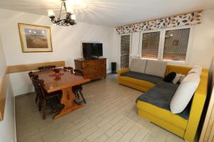 a living room with a couch and a table at Valley View Holiday Home with Sauna Mrak in Slap ob Idrijci +45 photos