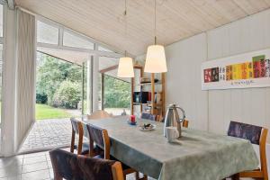 a dining room with a table and chairs at LF15191-Hojslev-Ternevej-31 in Højslev +23 photos