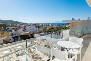 a balcony with chairs and a view of the city at Vila Antonio in Ksamil