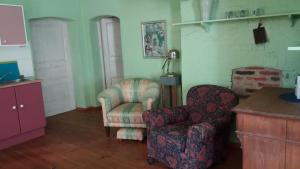 a living room with a couch and a chair and a table at Bülitz33 in Luckau