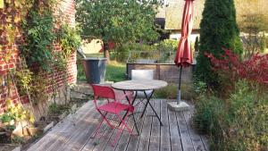 a table and two chairs and an umbrella on a patio at Bülitz33 in Luckau