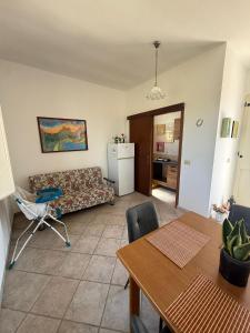 a living room with a couch and a table at Villa Sofia in Sogliano Cavour