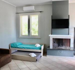 a living room with two beds and a fireplace at Villa Sofia in Sogliano Cavour