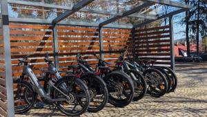 a group of bikes lined up against a wall at Hotel Dobry Klimat in Szklarska Poręba