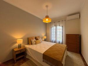 a bedroom with a large bed and a window at Three Sisters in Altura