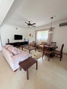 a living room with a couch and a table at Nortram Homes - Adenta in Apenkwa