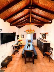a living room with a large wooden table and chairs at Diaks Tower Sunset Sea View Mani in Pyrgos Dirou