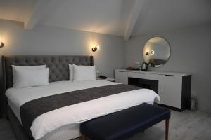 a bedroom with a large bed and a mirror at Zelif Otel Havza in Havza +59 photos
