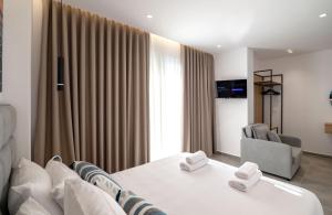 a hotel room with a bed and a chair at Vila Antonio in Ksamil