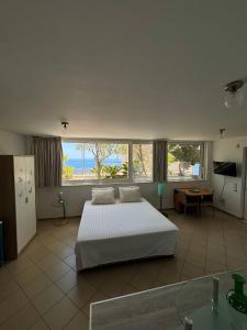 a bedroom with a bed and a view of the ocean at Viva B&B in Anavyssos