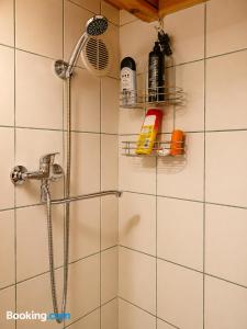 a bathroom with a shower with a shower head at Peaceful Nature Cottage near Talsi with Hot Tub, Sauna & Pond, Camping Ives in Talsi