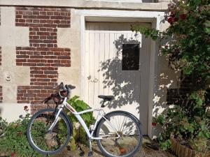 a bike parked in front of a house at Clos Florésine B&B in Venette