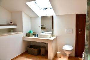 a bathroom with a sink and a mirror at Centro mare residence affitta alloggi in Porto Torres +39 photos