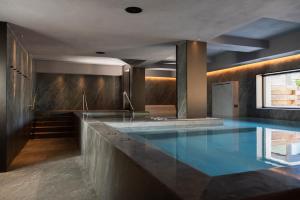 a large swimming pool in a building at Hotel Livata Mountain Wellness in Subiaco