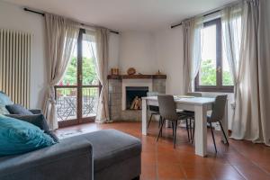 a living room with a table and a fireplace at Casa Anna in Lierna
