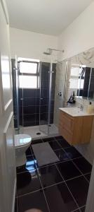 a bathroom with a toilet and a sink and a shower at Villa Golden Coast - Lagos in Lagos +47 photos