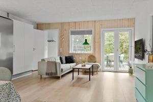 a living room with a couch and a table at LF14143-Spottrup-Basaltvej-1 in Spottrup
