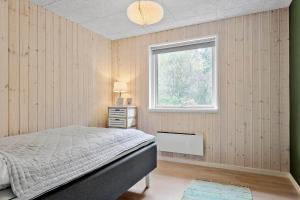 a bedroom with a bed and a window at LF14143-Spottrup-Basaltvej-1 in Spottrup