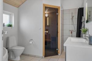 a bathroom with a toilet and a sink and a shower at LF15028-Skals-Lynderup-Strand-6 in Skals +14 photos