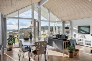 a living room with a table and a couch at LF15028-Skals-Lynderup-Strand-6 in Skals