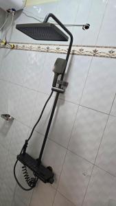 a hair dryer on the wall of a bathroom at kuza Suites Mbale in Mbale +29 photos