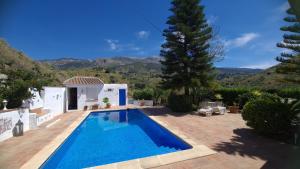 a swimming pool in the backyard of a villa at Finca Mulo Arriba in Canillas de Aceituno
