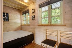 a small bedroom with a bed and a chair at LF15023-Skals-Lynderup-Strand-2 in Skals