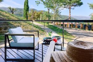 a balcony with a chair and a view of a mountain at Hotel Aquafalls in Caniçada