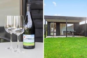 a bottle of wine sitting next to a wine glass at LF13170-Nykobing-mors-Havevej-22 in Nykøbing Mors +16 photos