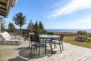 a patio with a table and chairs on a deck at LF18110-Veslos-Agerovej-13 in Vesløs