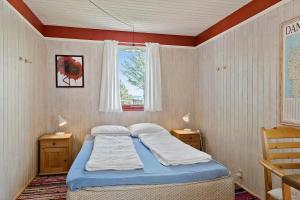 a bedroom with a bed and a window at LF18110-Veslos-Agerovej-13 in Vesløs