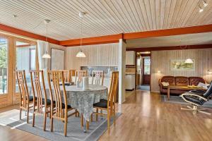 a dining room and kitchen with a table and chairs at LF18110-Veslos-Agerovej-13 in Vesløs