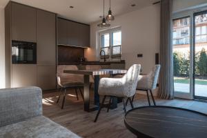 a kitchen with a table and chairs in a room at Egerner Chalet in Rottach-Egern