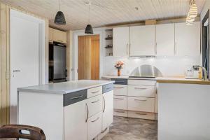 a kitchen with white cabinets and a gray counter top at LF14102-Roslev-Eskovvej-102 in Roslev